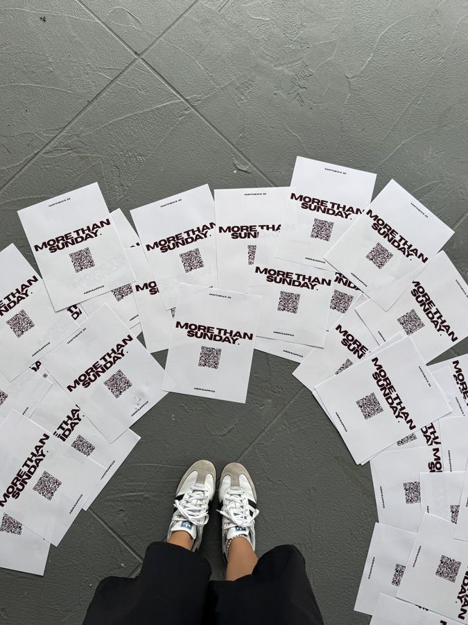 More Than Sunday flyers with QR codes spread on the floor